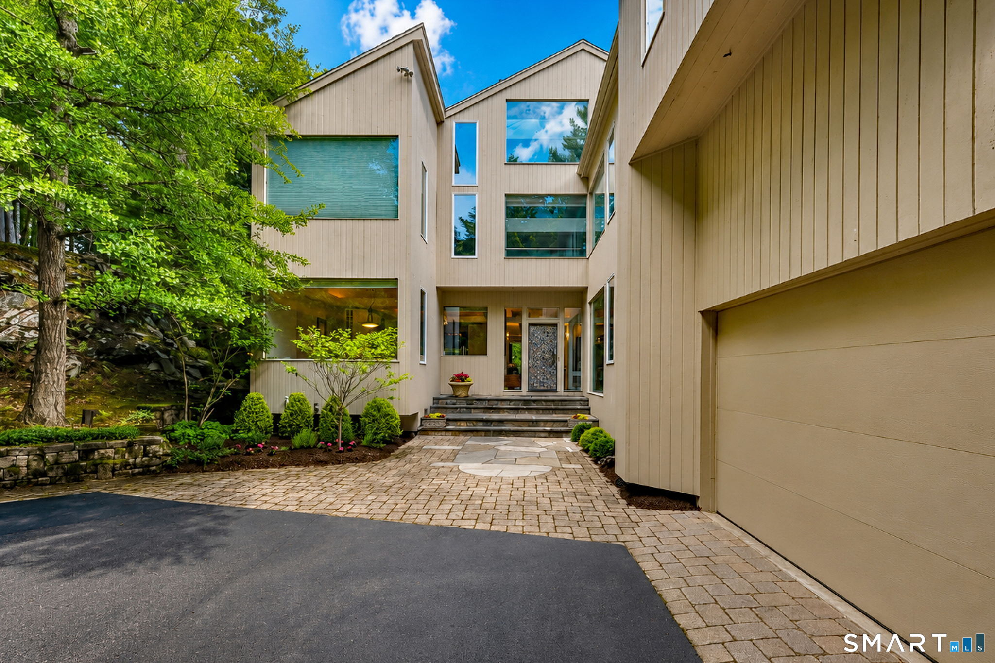 25 Milan Road Woodbridge, CT 06525 - Photo 2 of 40 a front view of a house with a yard and outdoor seating
