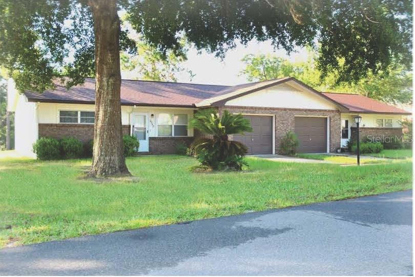 8342-44 Southwest 101st Place Road Ocala, FL 34481 - Photo 1 of 1 a front view of house with yard and green space