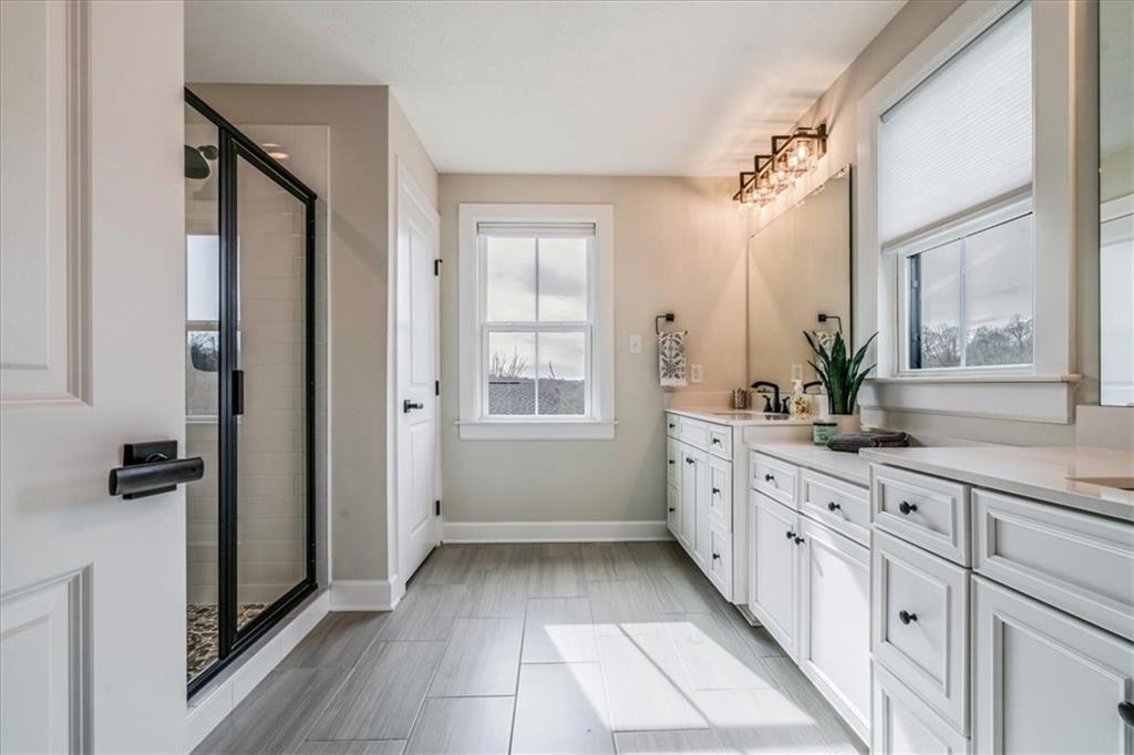 348 Juniper Way Canonsburg, PA 15317 - Photo 17 of 25 a bathroom with a double vanity sink a mirror a window and a shower