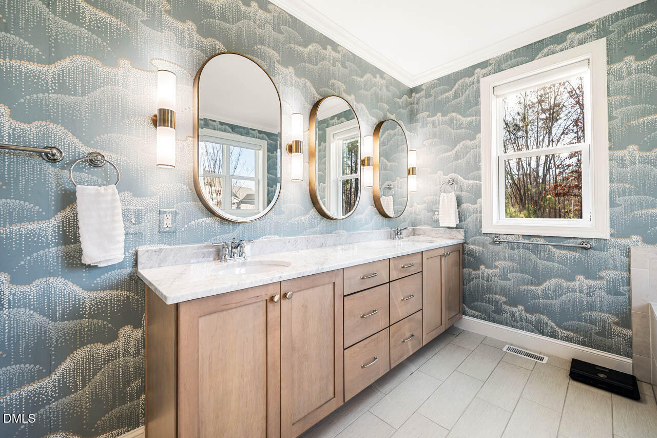56 Post Oak Road Chapel Hill, NC 27516 - Photo 24 of 84 a bathroom with a double vanity sink and a mirror