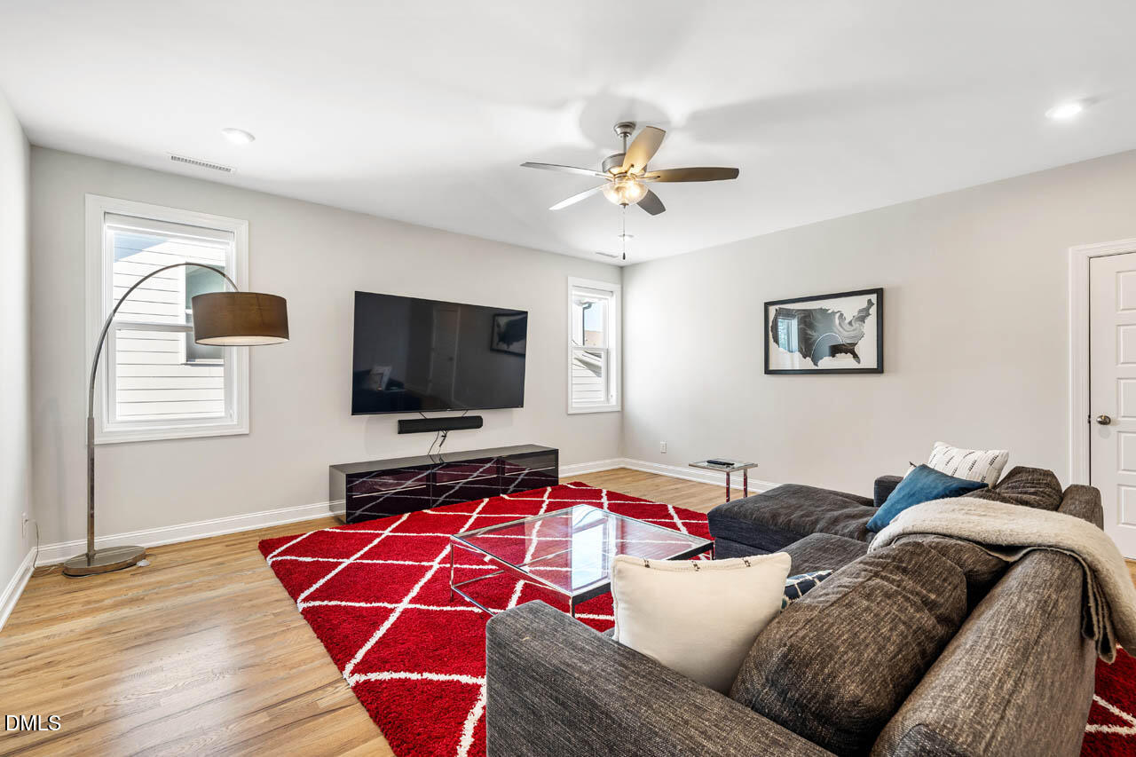 56 Post Oak Road Chapel Hill, NC 27516 - Photo 32 of 84 a living room with furniture and a flat screen tv