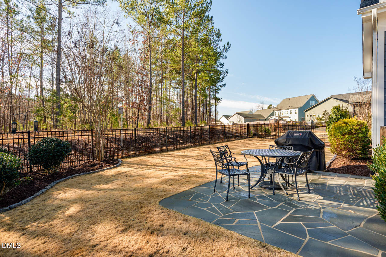 56 Post Oak Road Chapel Hill, NC 27516 - Photo 6 of 84 a view of a patio with table and chairs and potted plants