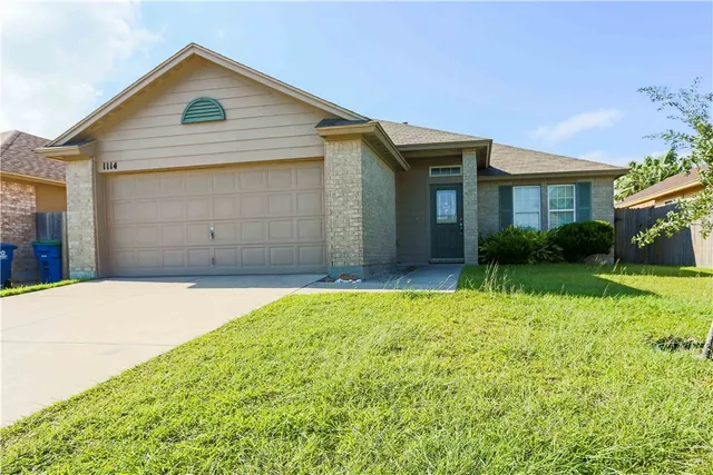 a view of backyard of house with green space