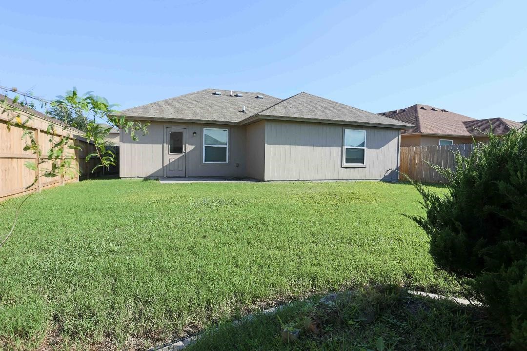 1114 Livermore Street Portland, TX 78374 - Photo 16 of 16 a front view of a house with a yard and garage