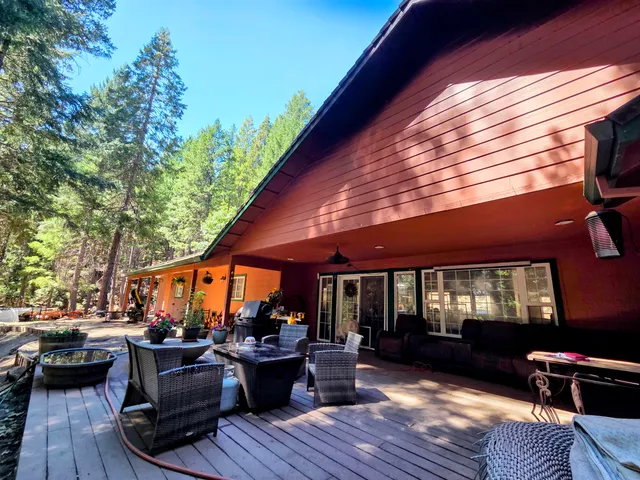 a view of house with deck and outdoor seating