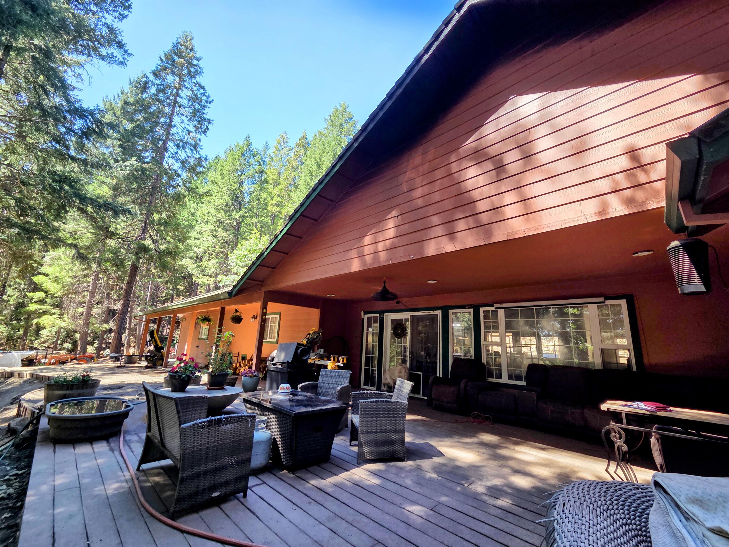 a view of house with deck and outdoor seating