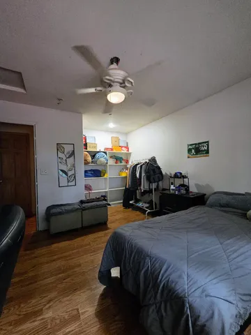 a bedroom with a bed and a large window with outer view