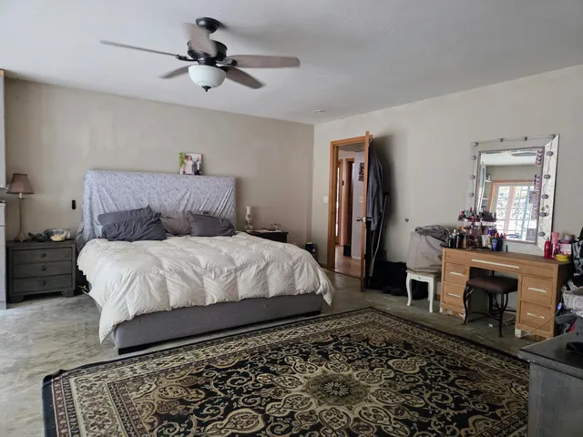 a room with pool table and windows