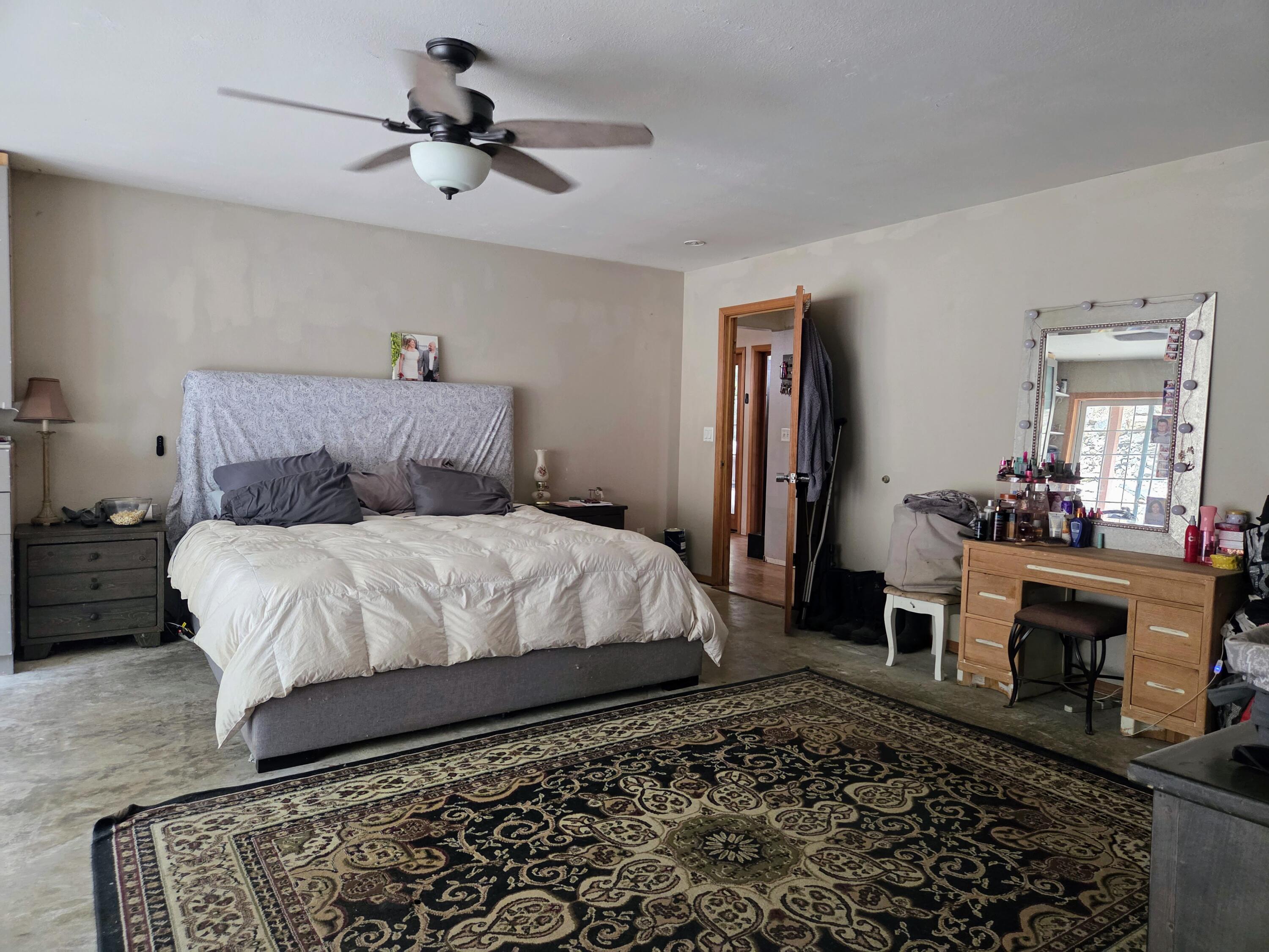 2940 Bear Creek Road Lewiston, CA 96052 - Photo 15 of 21 a bedroom with a bed and a chandelier