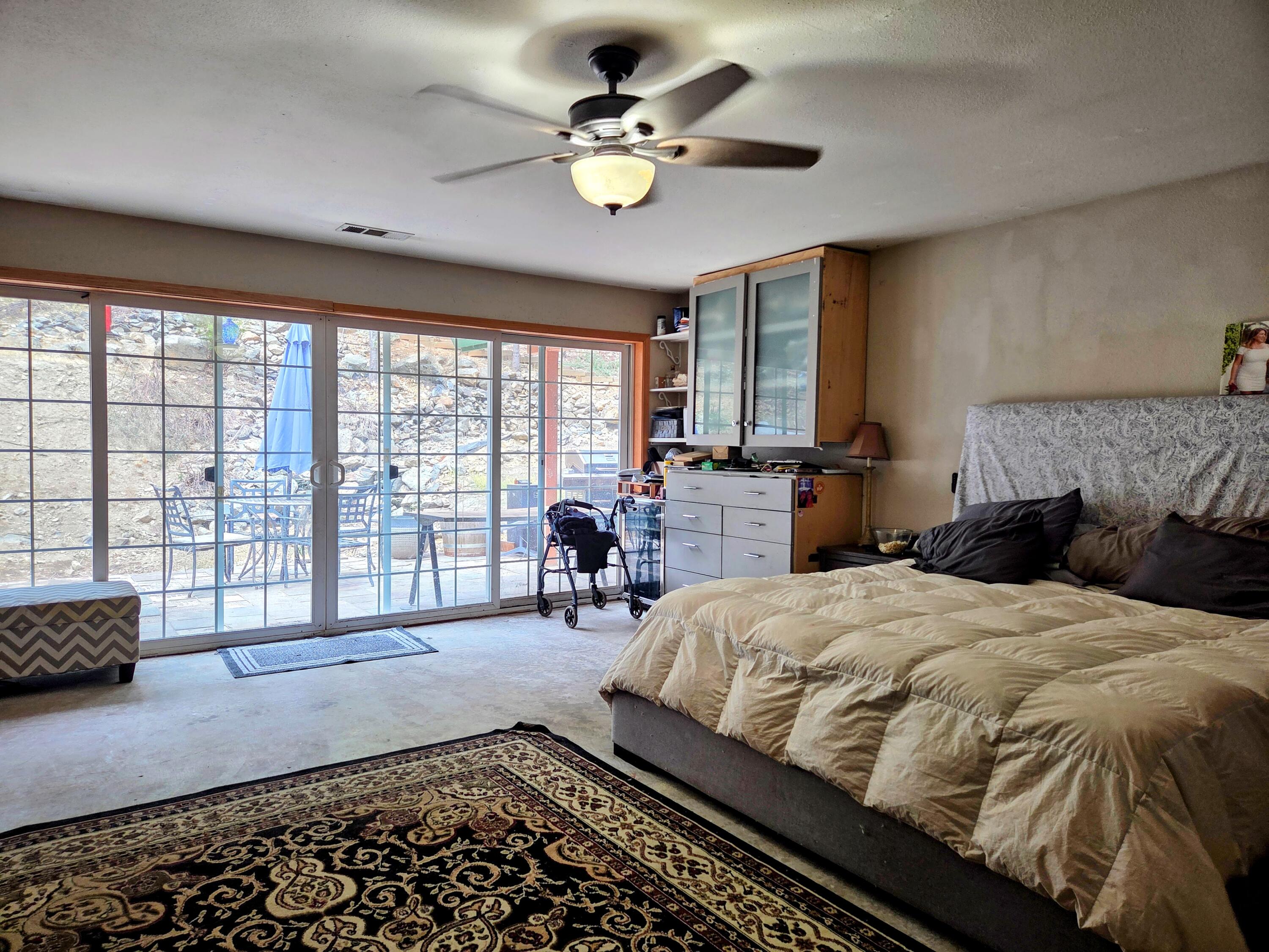 2940 Bear Creek Road Lewiston, CA 96052 - Photo 16 of 21 a bedroom with a bed and a large window with outer view