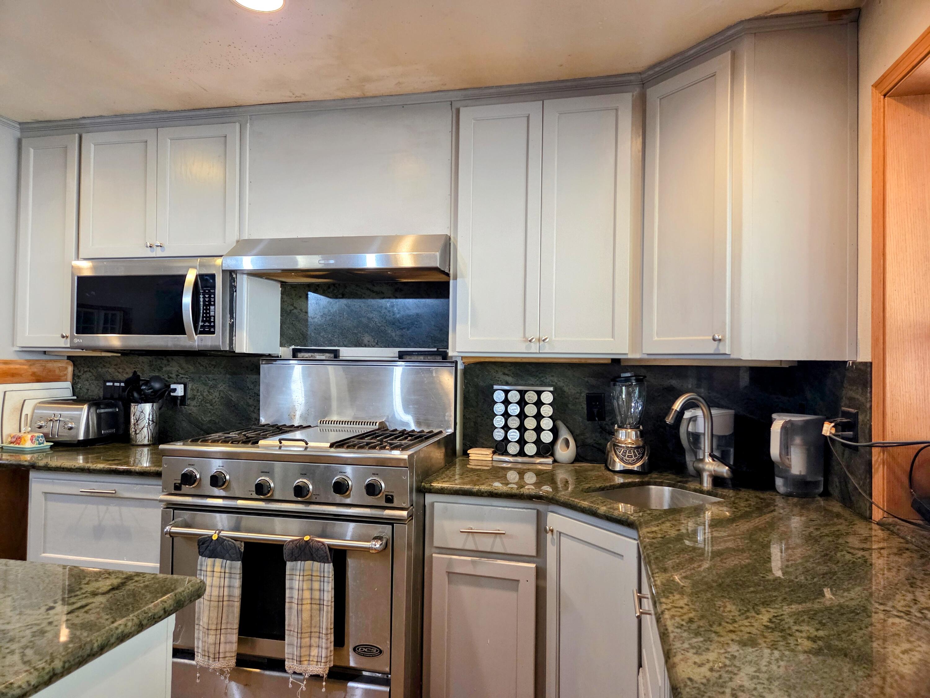 2940 Bear Creek Road Lewiston, CA 96052 - Photo 9 of 21 a kitchen with stainless steel appliances granite countertop a stove and a microwave
