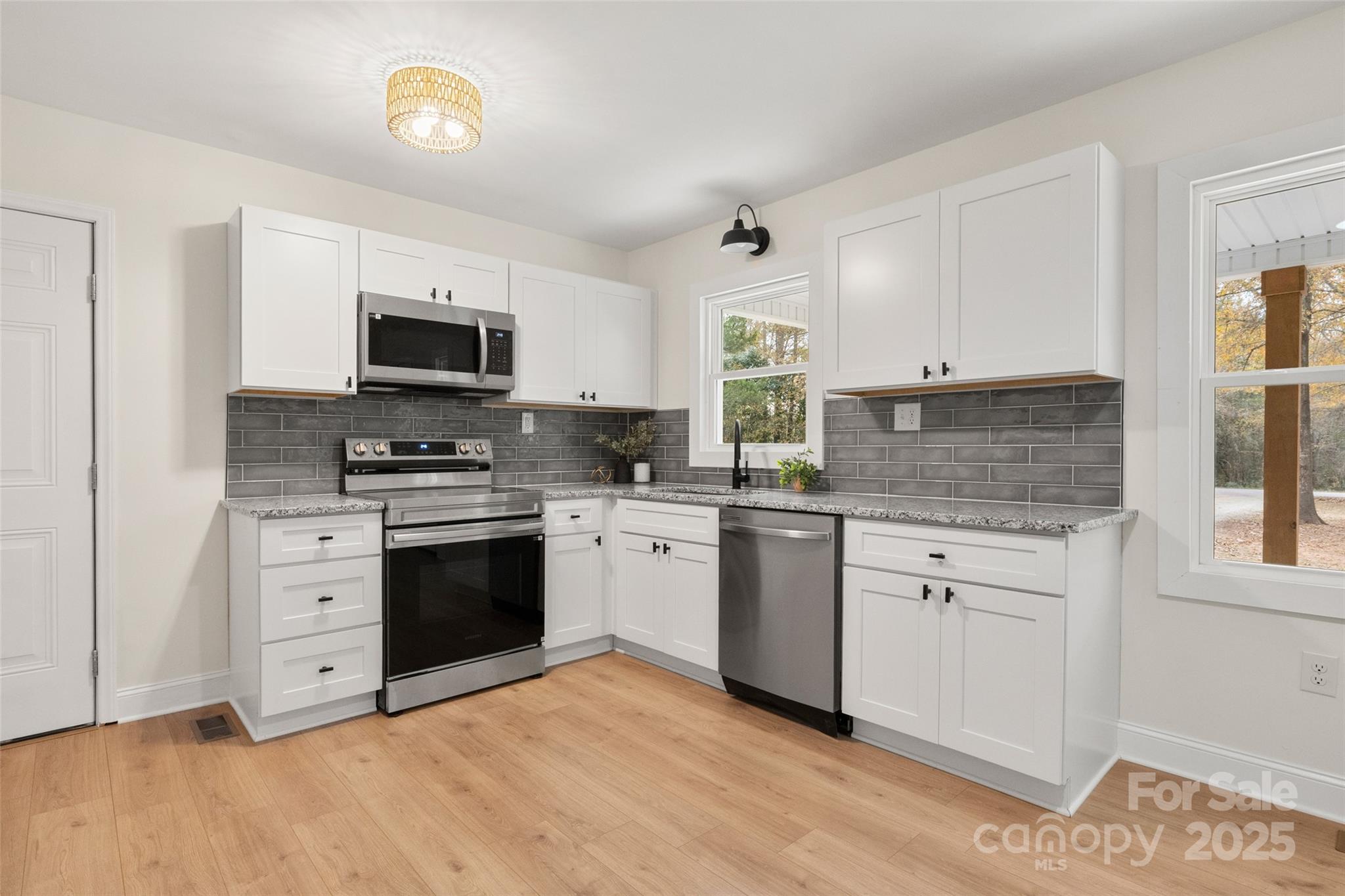 1946 Robert Usher Road Lancaster, SC 29720 - Photo 6 of 15 a kitchen with granite countertop a sink cabinets stainless steel appliances and a window