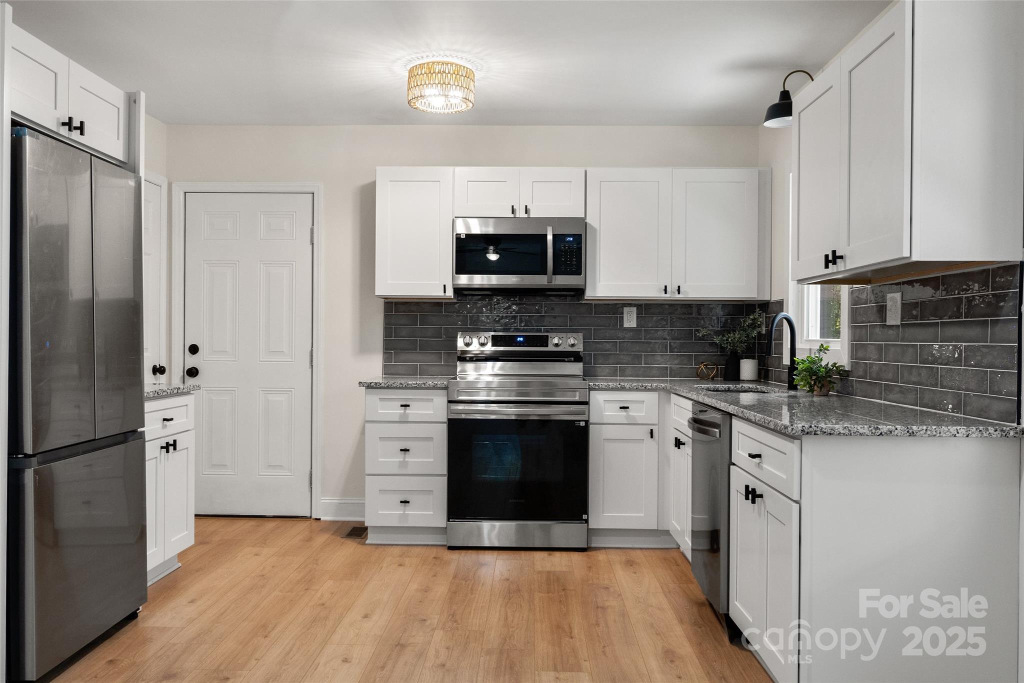 1946 Robert Usher Road Lancaster, SC 29720 - Photo 8 of 15 a kitchen with stainless steel appliances granite countertop a stove a sink and a refrigerator