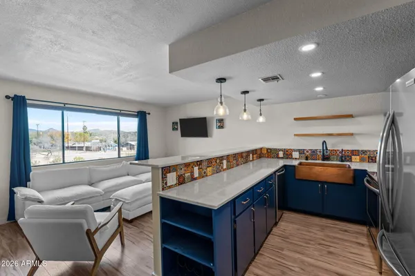 a kitchen with stainless steel appliances granite countertop a stove and a refrigerator