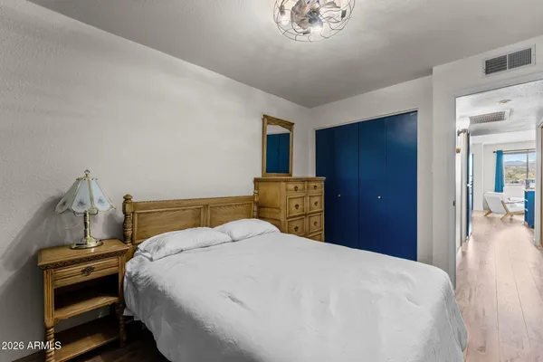 a bedroom with a bed and a chandelier