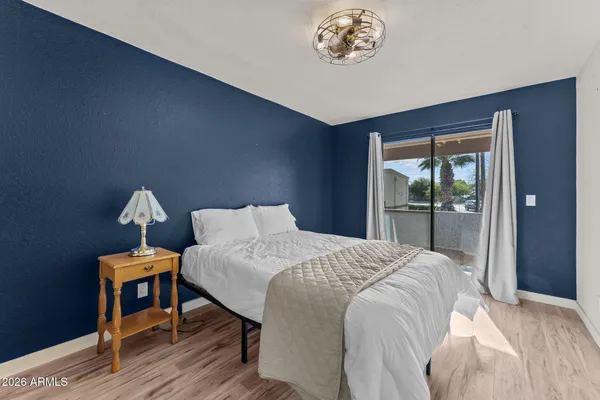 a bed sitting in a bedroom next to a window