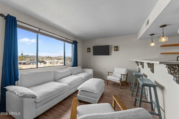 a living room with furniture and a large window