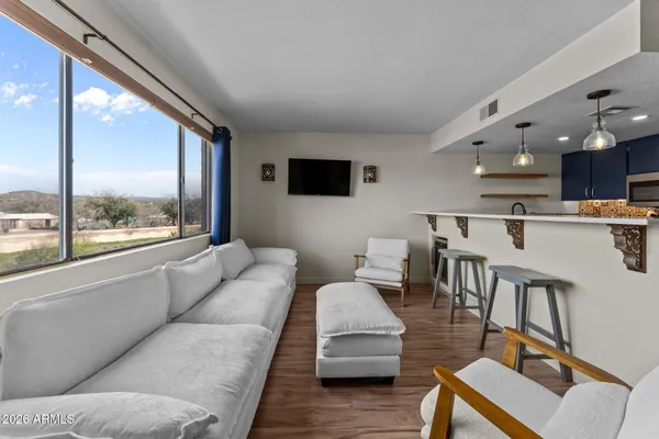 a living room with furniture and a large window