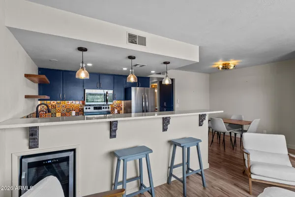 a kitchen with a table chairs and wooden floor