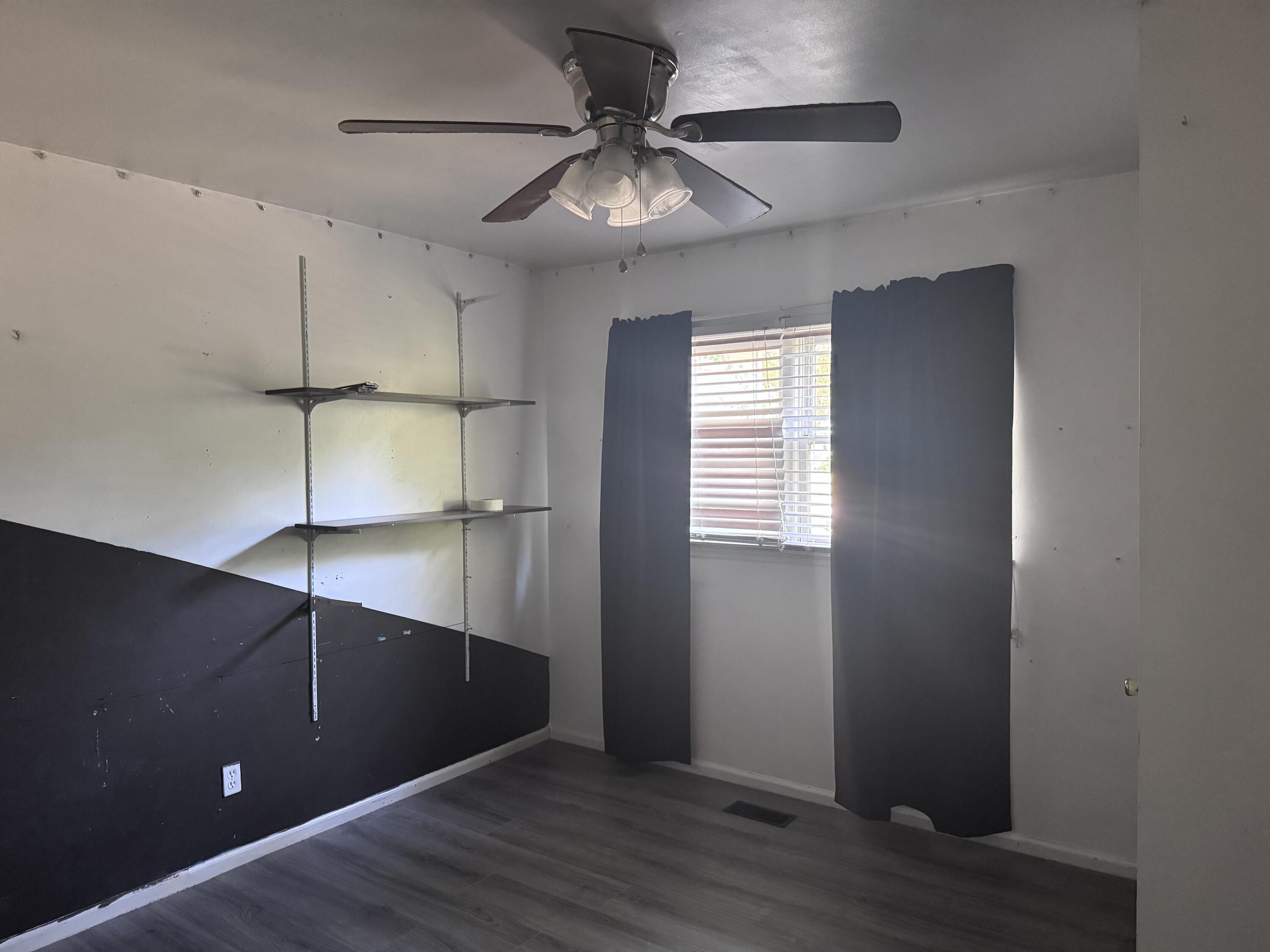 127 Jackson Road Jackson, SC 29831 - Photo 11 of 21 a view of an empty room with wooden floor and a ceiling fan