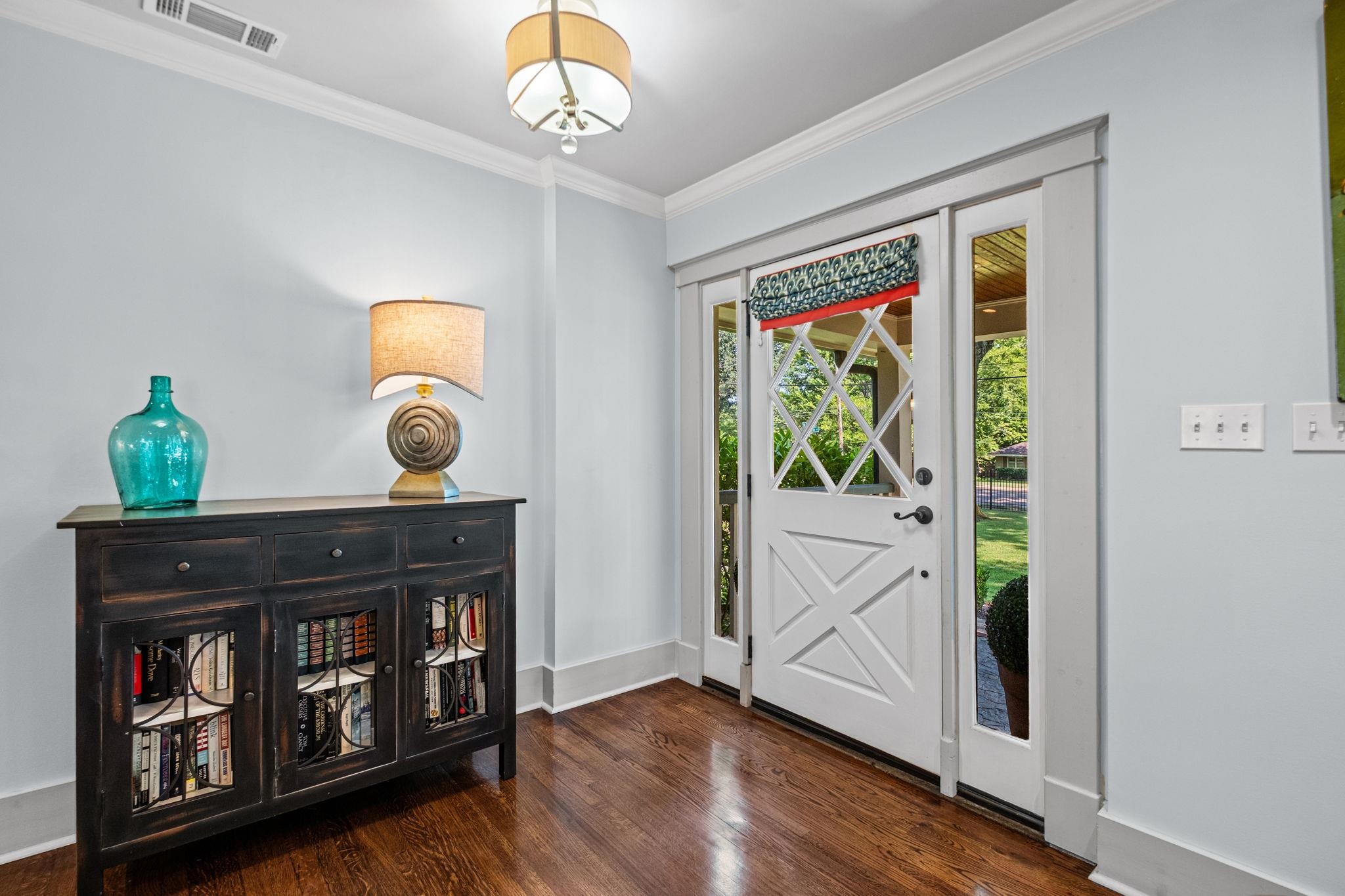 5079 Walnut Grove Road Memphis, TN 38117 - Photo 9 of 40 Wood-finish flooring, white trim, crown molding, double doors, and a decorative transom window