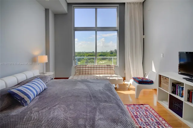 a living room with furniture and a floor to ceiling window