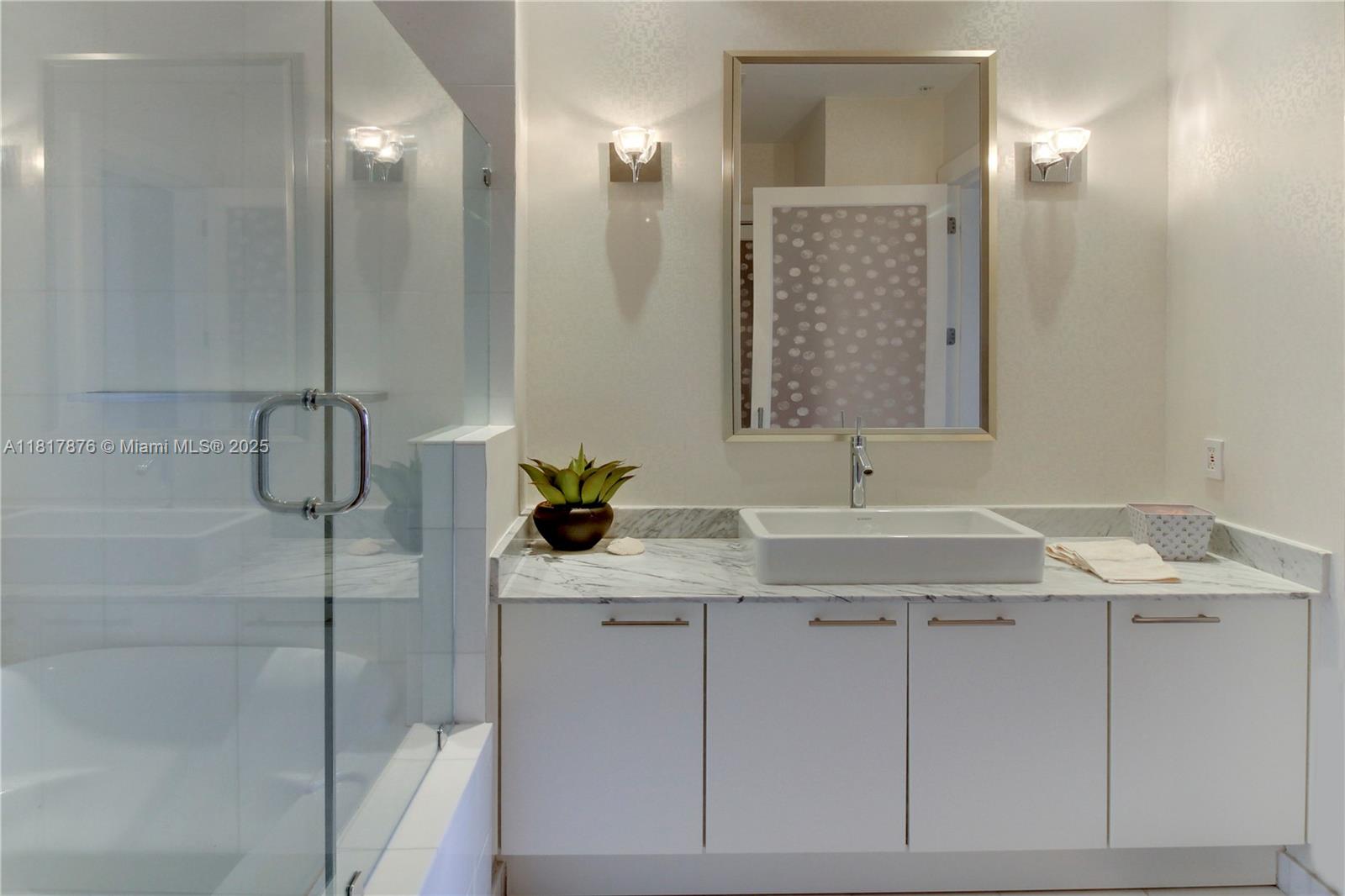 2001 Meridian Avenue, Unit PH21 Miami Beach, FL 33139 - Photo 12 of 14 a bathroom with a sink and mirror