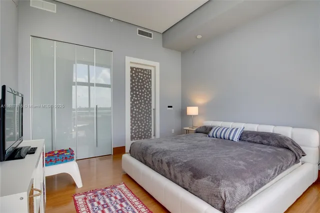 a bedroom with a bed and a couch