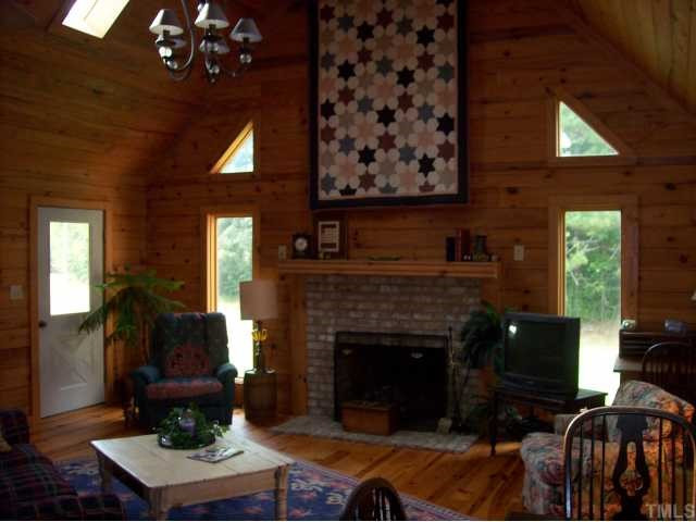 493 McGee Road Benson, NC 27504 - Photo 6 of 12 One of the homes most attractive features is the soaring cathedral ceiling in the family room and the fireplace centered between the windows with a breathtaking view of the woods. Skylights keep the home bright. Den/Family/Great Room