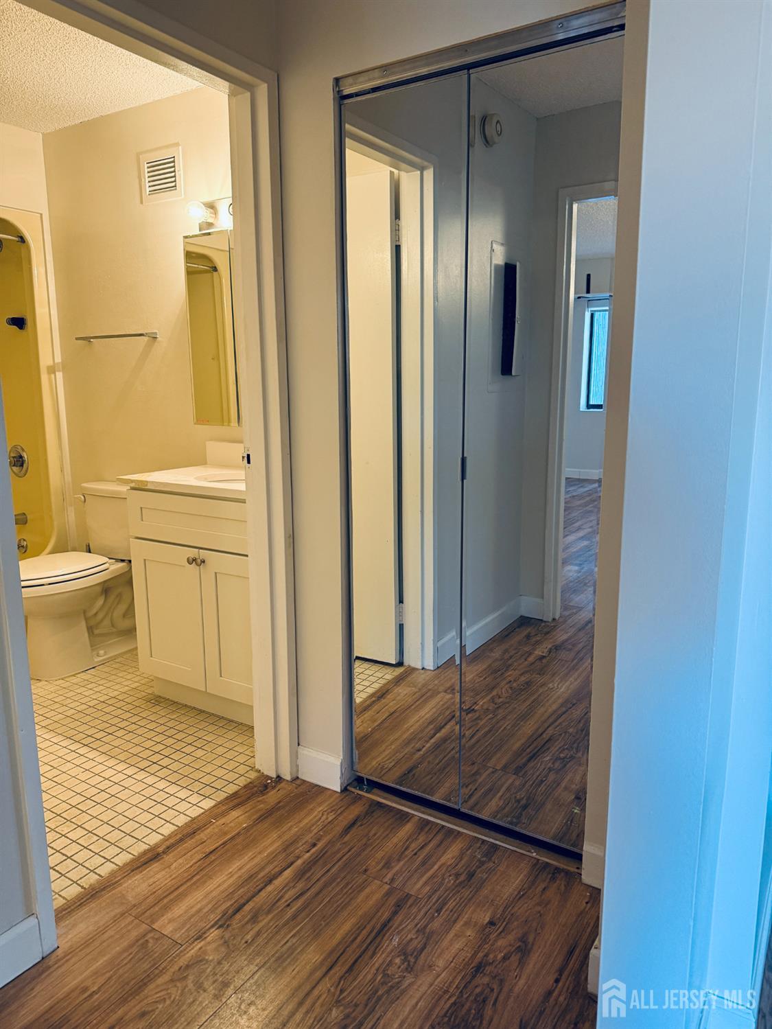 10 North Wood Avenue, Unit 314 Linden, NJ 07036 - Photo 14 of 18 a view of a bathroom with a shower and a toilet