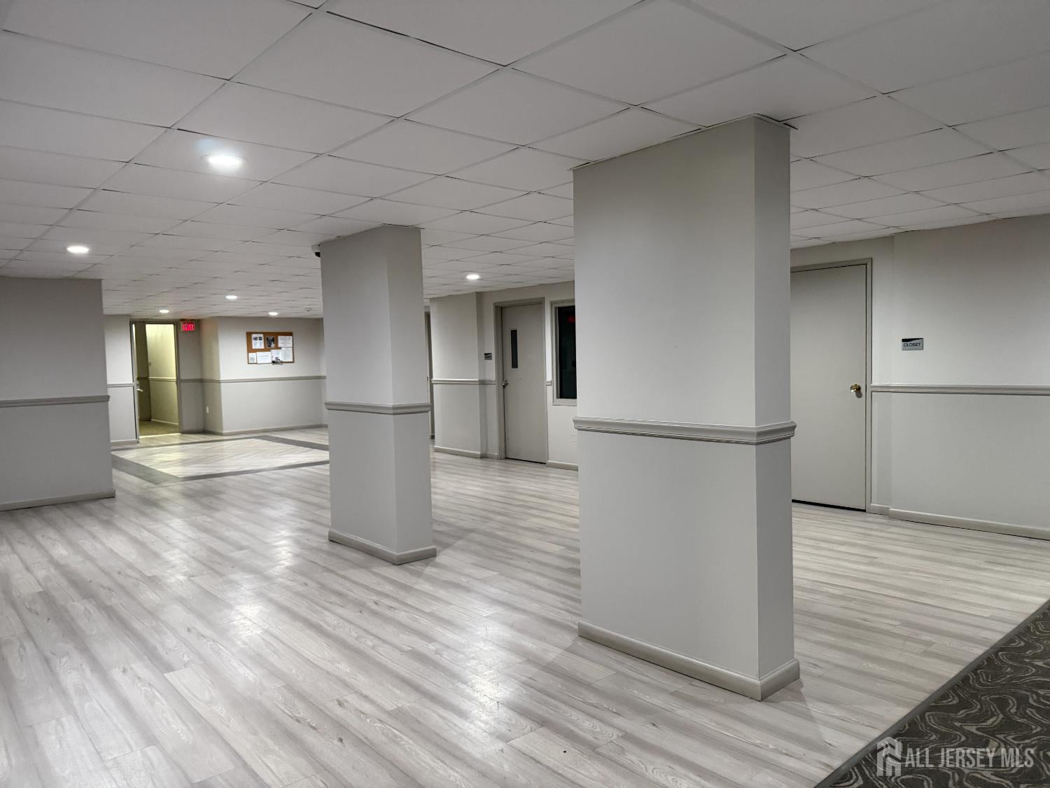10 North Wood Avenue, Unit 314 Linden, NJ 07036 - Photo 16 of 18 a view of empty room with wooden floor and kitchen