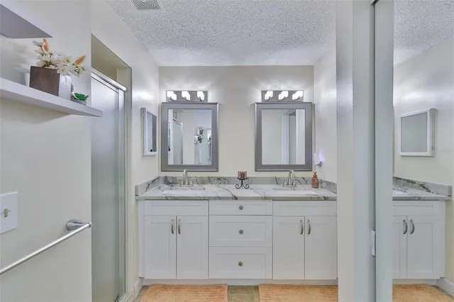 a bathroom with a double vanity sink and a mirror