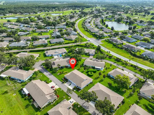 an aerial view of residential houses with outdoor space and street view