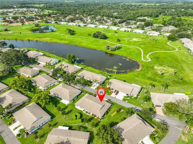 an aerial view of a houses with yard