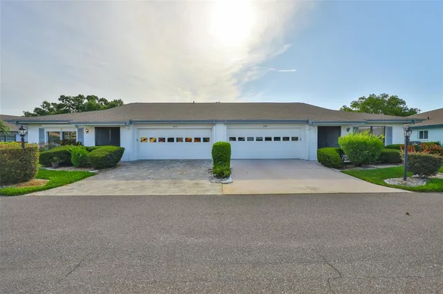 a view of house with outdoor space and parking
