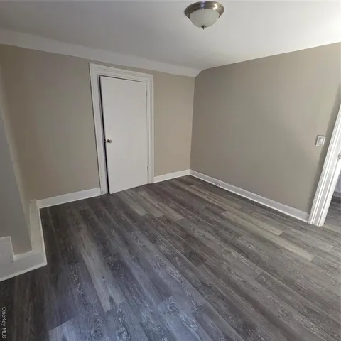 an empty room with wooden floor