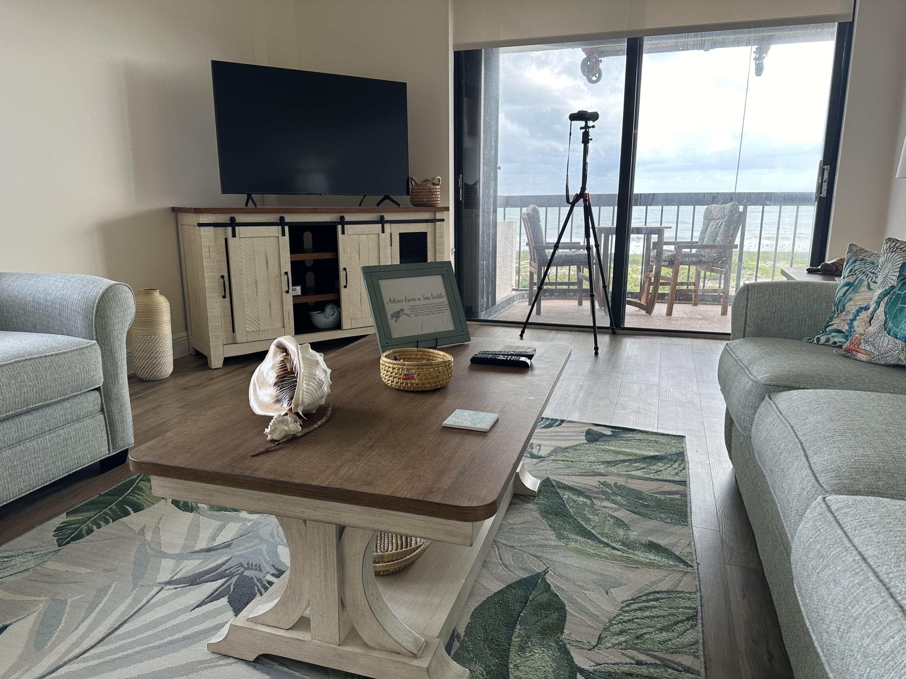 3100 North Hwy A1A, Unit 502 Fort Pierce, FL 34949 - Photo 12 of 44 a living room with furniture and a flat screen tv