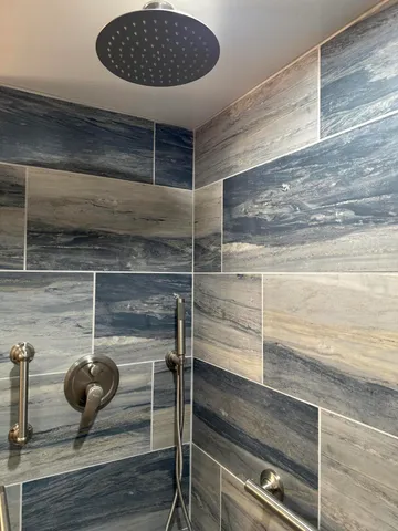 a bathroom with a shower and a sink