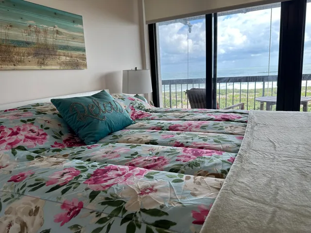 a bedroom with a bed a window and lamps