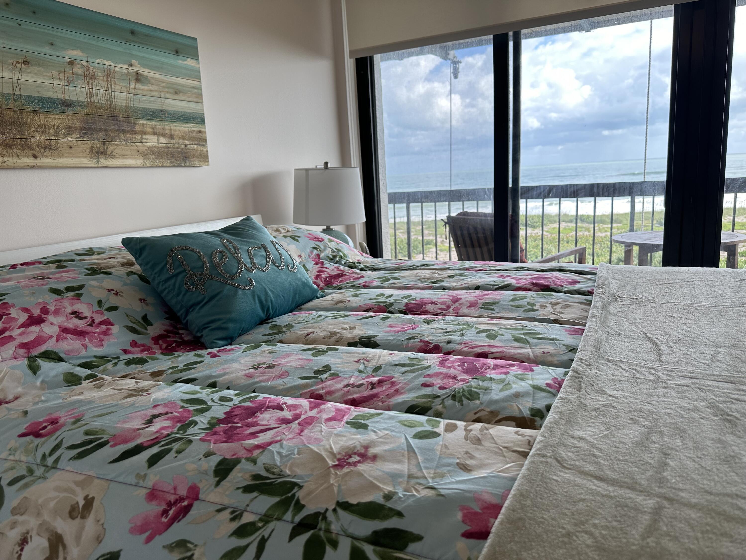 3100 North Hwy A1A, Unit 502 Fort Pierce, FL 34949 - Photo 23 of 44 a bedroom with a bed and a painting on the wall