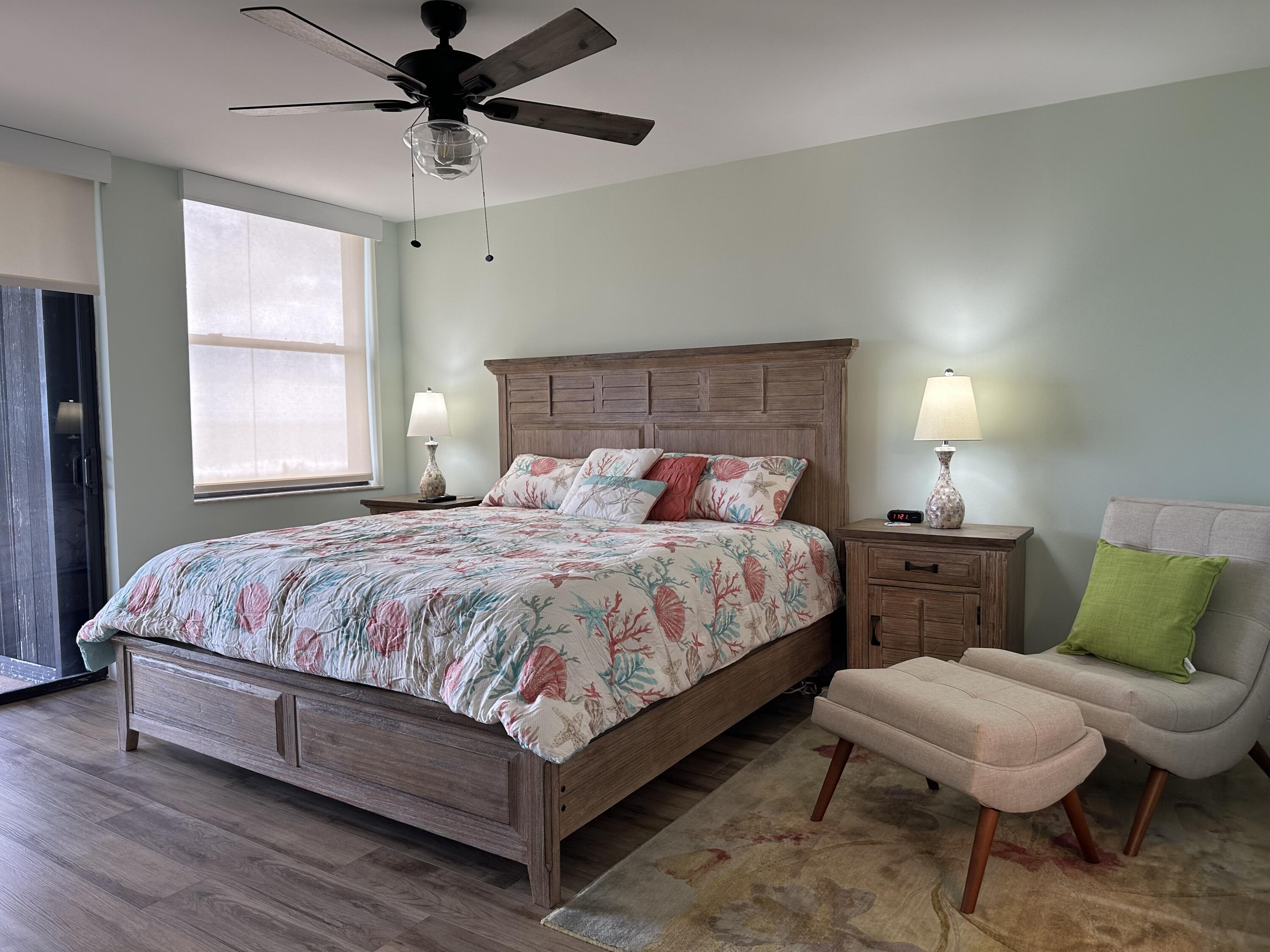 3100 North Hwy A1A, Unit 502 Fort Pierce, FL 34949 - Photo 25 of 44 a bedroom with a bed a window and lamps