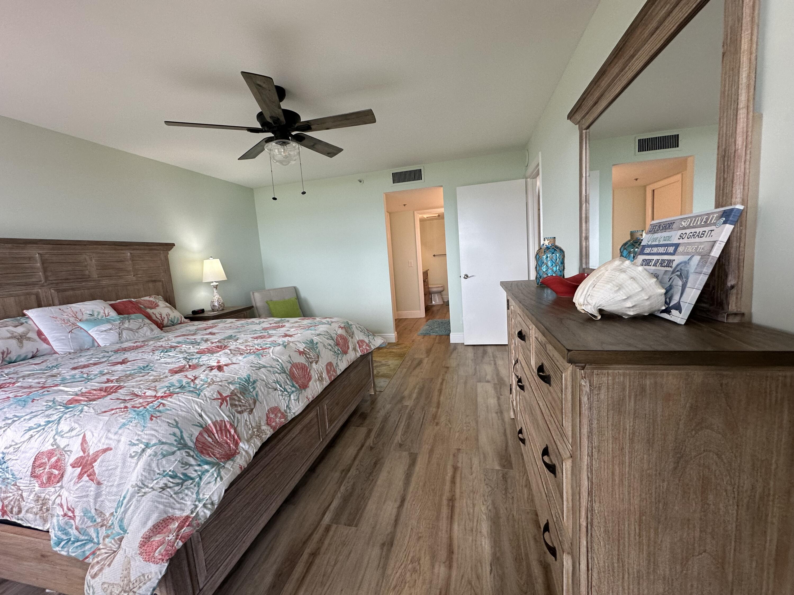 3100 North Hwy A1A, Unit 502 Fort Pierce, FL 34949 - Photo 27 of 44 a bedroom with a bed and wooden floor