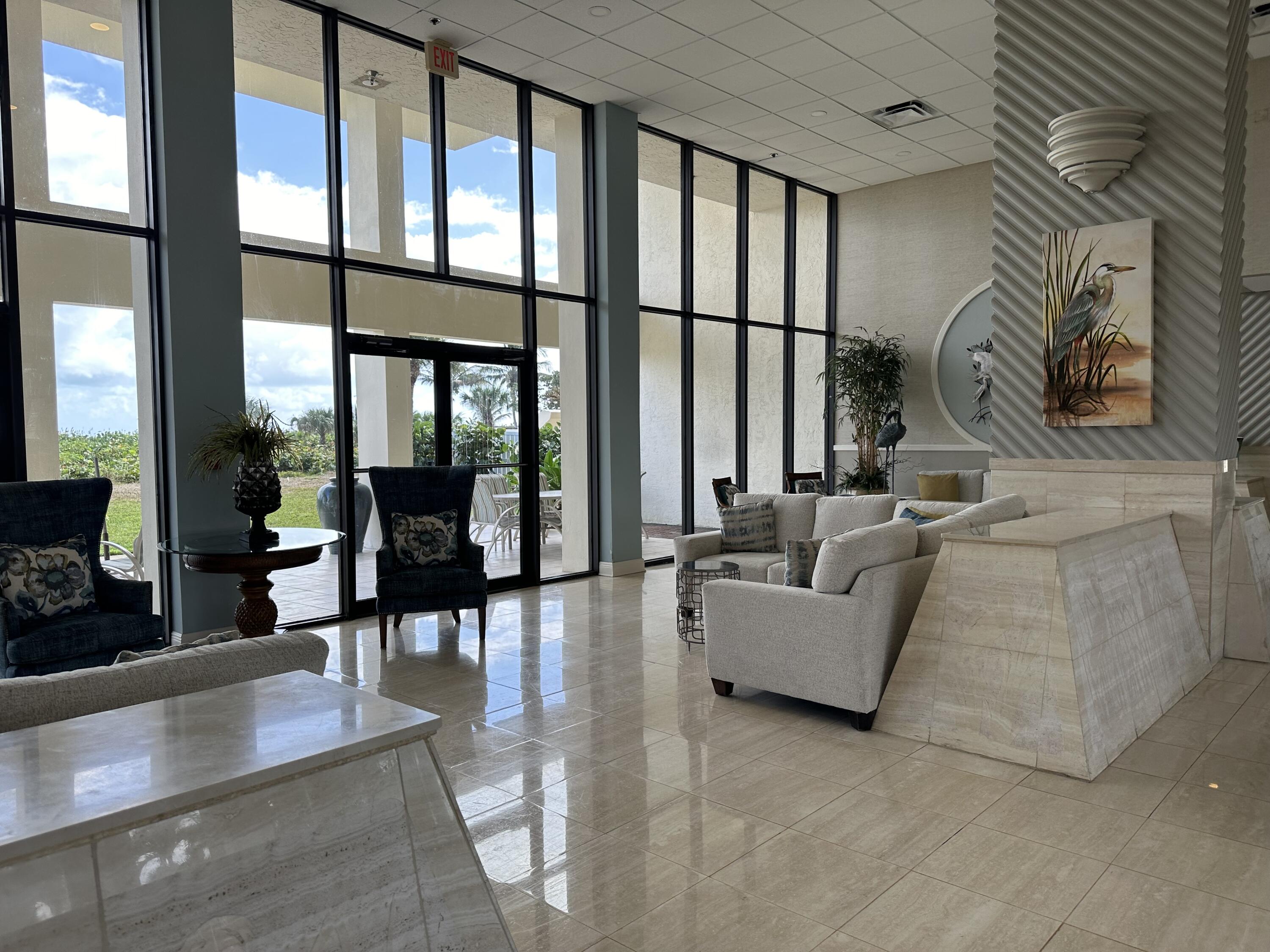 3100 North Hwy A1A, Unit 502 Fort Pierce, FL 34949 - Photo 38 of 44 a living room with furniture and large windows