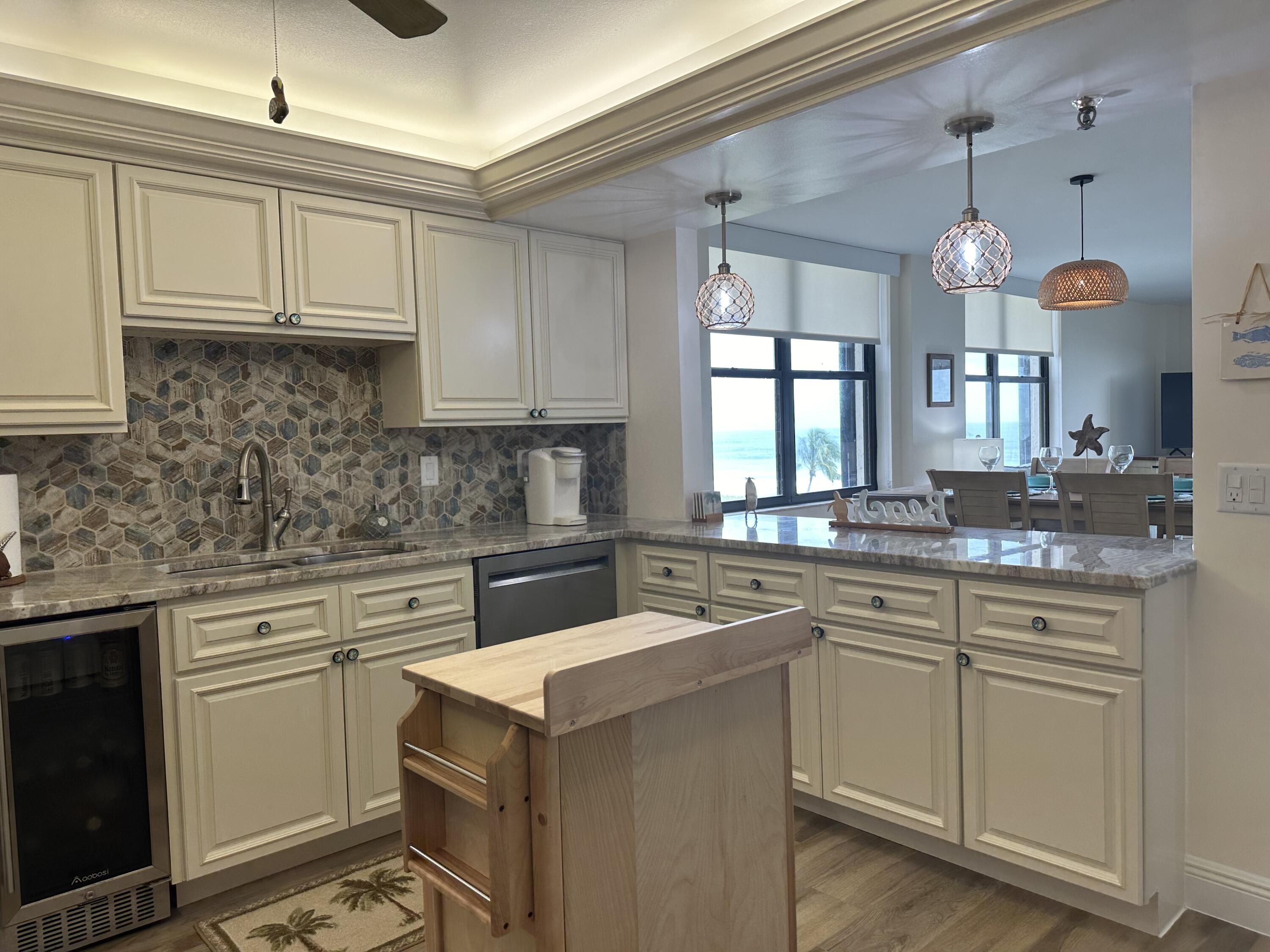 3100 North Hwy A1A, Unit 502 Fort Pierce, FL 34949 - Photo 4 of 44 a kitchen with a sink cabinets and window