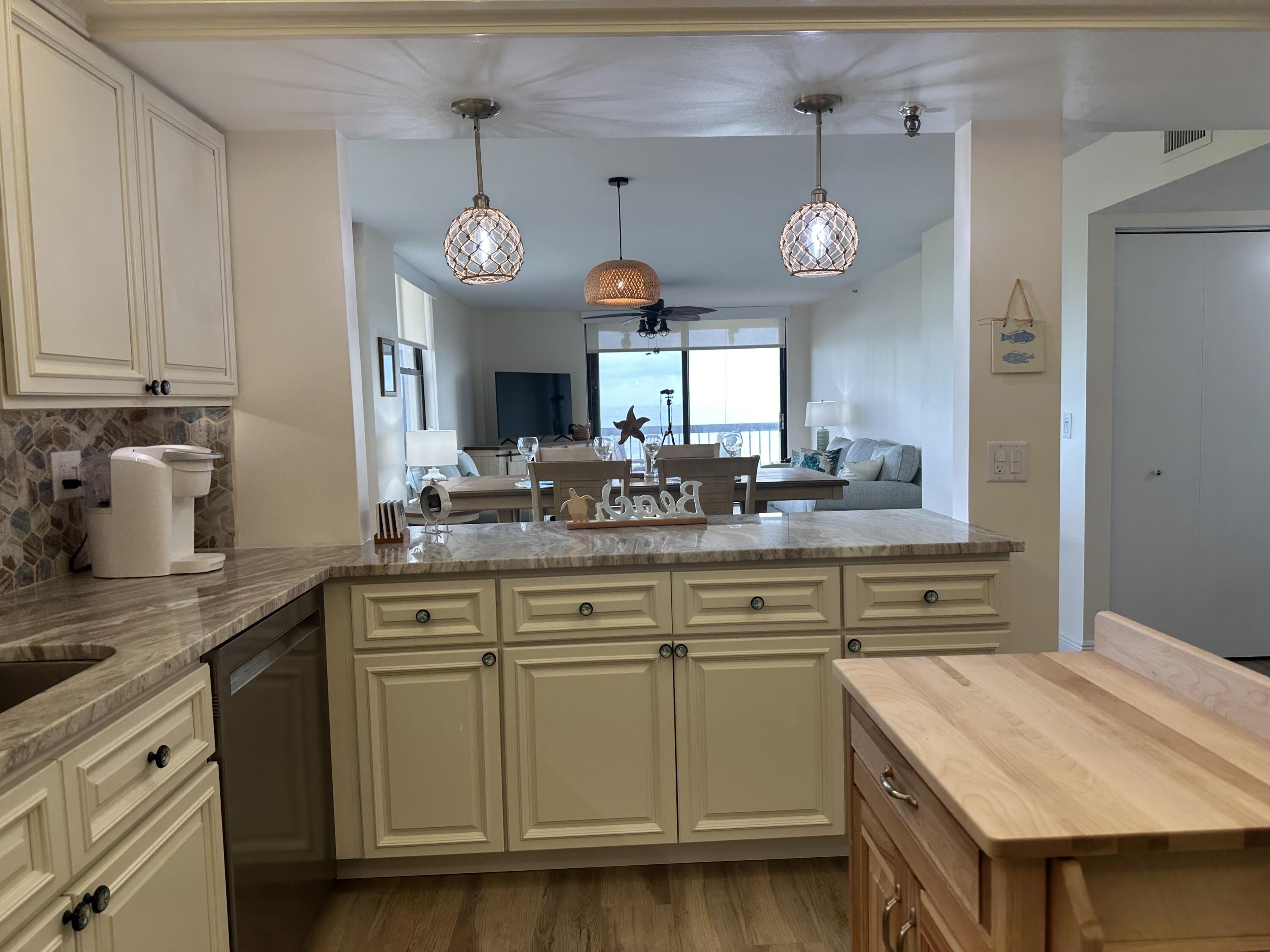 3100 North Hwy A1A, Unit 502 Fort Pierce, FL 34949 - Photo 5 of 44 a kitchen with cabinets appliances and a clock