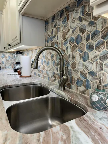 a kitchen with a stove a sink and a microwave