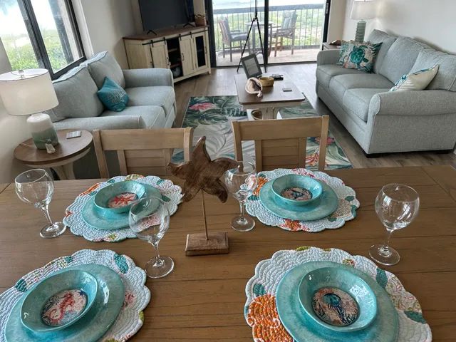 a living room with furniture a large window and a flat screen tv