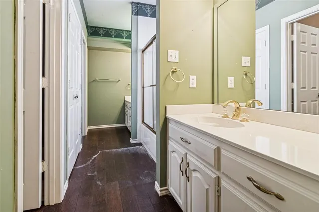 a spacious bathroom with a double vanity sink and a mirror