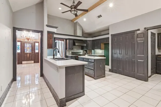 a kitchen with stainless steel appliances kitchen island granite countertop a sink and cabinets