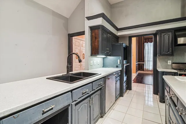 a kitchen that has a sink and a stove